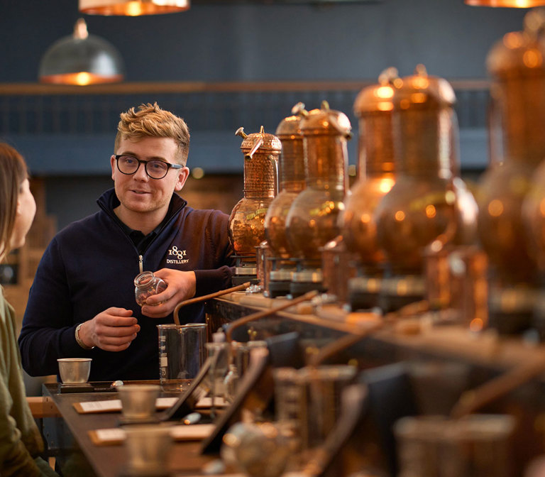 A couple learning about gin-making at 1881 distillery